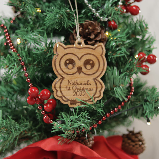 Owl shaped wood ornament that is coated with UV resin on a mini Christmas tree. Nathaniel's 1st Christmas 2022 is etched in the ornament.